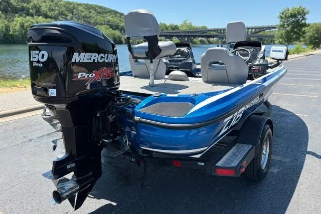 Slide: The Image of Blue 2018 Nitro Z18 boat with Mercury 150 Pro XS engine, parked near a scenic river. - 22