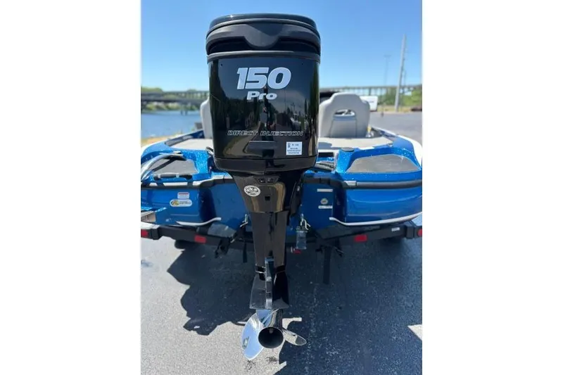 Slide: The Image of 2018 Nitro Z18 boat with 150 Pro outboard motor, parked near water. - 24