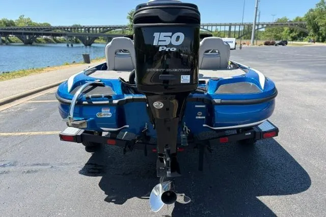 Slide: The Image of 2018 Nitro Z18 boat with 150 Pro motor, parked near a scenic river. - 25