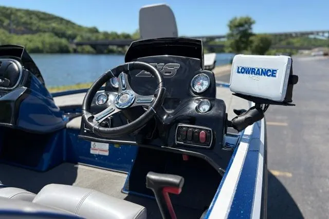 Slide: The Image of 2018 Nitro Z18 boat dashboard with steering wheel and Lowrance GPS by a scenic river. - 26