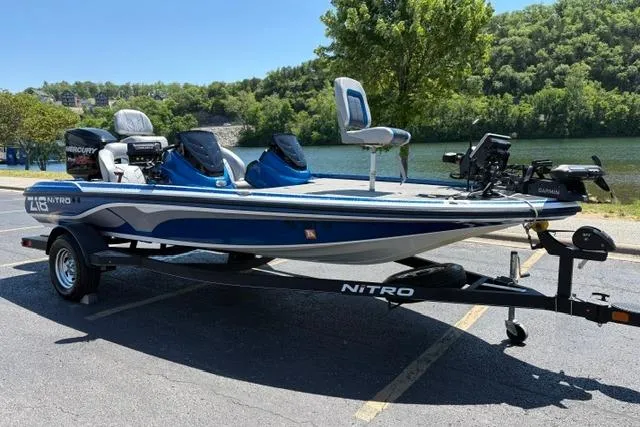 Slide: The Image of 2018 Nitro Z18 fishing boat on trailer by a scenic lake. - 4