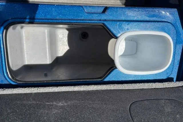 Slide: The Image of Storage compartment in a 2018 Nitro Z18 boat, featuring a blue and gray interior. - 56