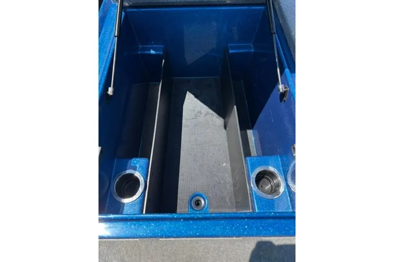Slide: The Image of Open storage compartment of a 2018 Nitro Z18 boat, featuring cup holders. - 59