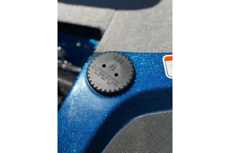 Slide: The Image of Close-up of a 2018 Nitro Z18 boat's oil cap on a sparkling blue surface. - 68
