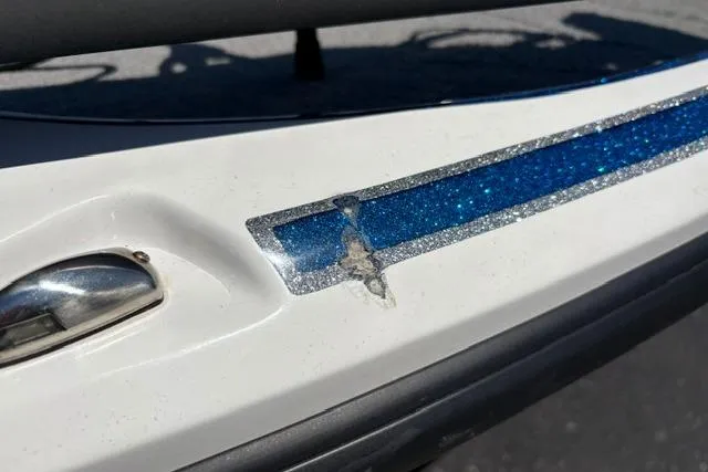 Slide: The Image of Close-up of 2018 Nitro Z18 boat with blue glitter stripe and minor surface damage. - 7
