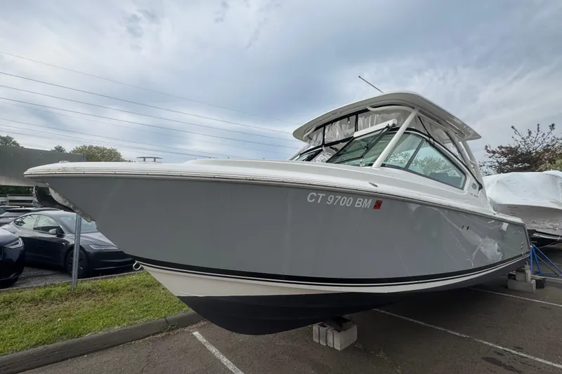 The Image of 2022 Pursuit DC 266 Dual Console boat on display in a parking lot. - 0