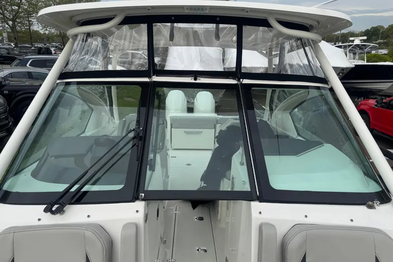 Slide: The Image of 2022 Pursuit DC 266 Dual Console boat with sleek windshield and modern design. - 19