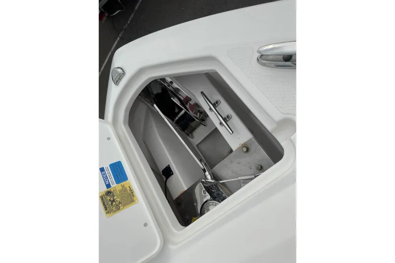 Slide: The Image of Anchor compartment of 2022 Pursuit DC 266 Dual Console boat, showcasing storage details. - 20