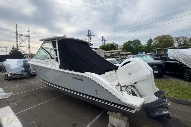 Slide: The Image of 2022 Pursuit DC 266 Dual Console boat with Yamaha engine, parked outdoors. - 24