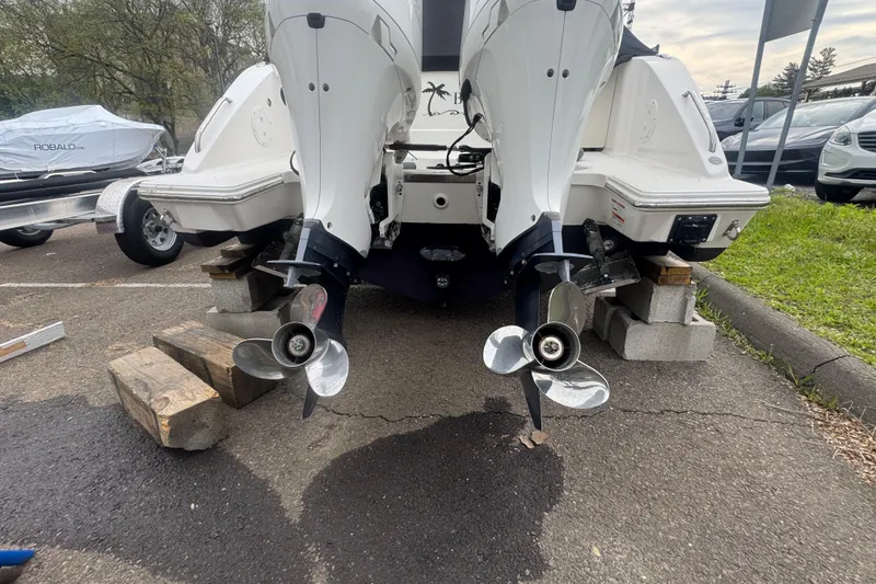 Slide: The Image of Rear view of 2022 Pursuit DC 266 Dual Console boat with dual outboard motors. - 25