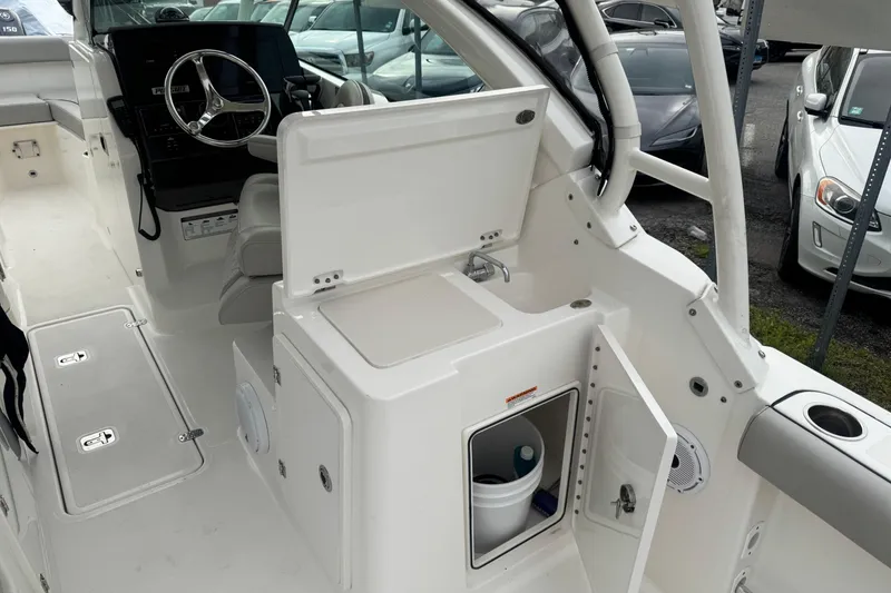 Slide: The Image of 2022 Pursuit DC 266 Dual Console boat interior with helm, storage, and seating. - 8