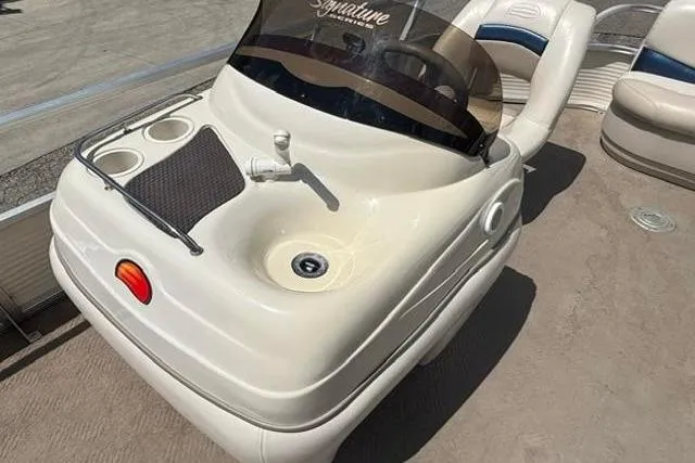 Slide: The Image of 2008 Sun Tracker Party Barge 18 DLX boat console with sink and cup holders. - 13