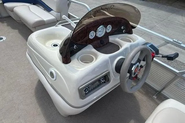 Slide: The Image of 2008 Sun Tracker Party Barge 18 DLX dashboard with steering wheel and gauges. - 14