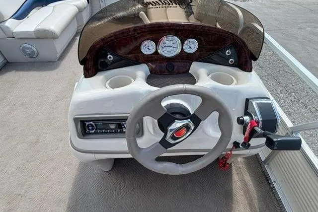 Slide: The Image of 2008 Sun Tracker Party Barge 18 DLX steering console with gauges and controls. - 15