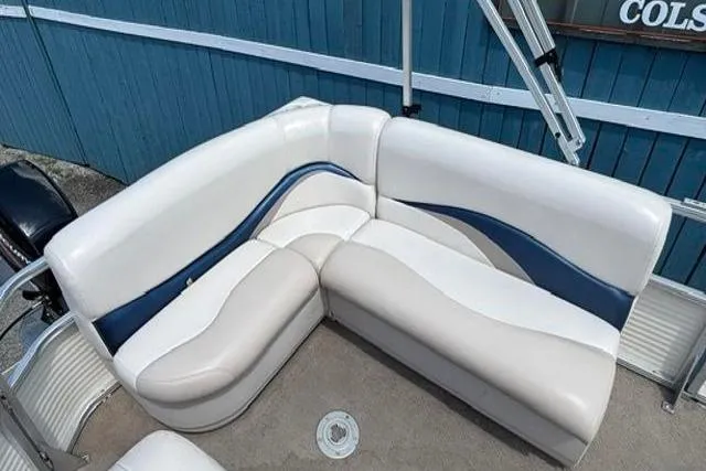 Slide: The Image of 2008 Sun Tracker Party Barge 18 DLX pontoon boat seating with blue and white upholstery. - 18