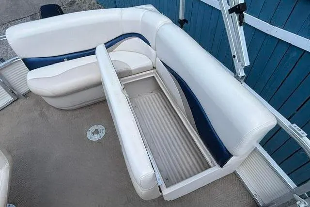 Slide: The Image of 2008 Sun Tracker Party Barge 18 DLX boat seating with storage compartment open. - 19