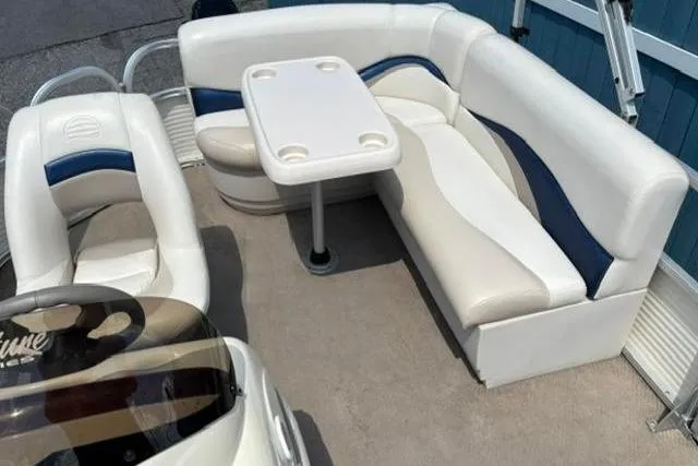 Slide: The Image of 2008 Sun Tracker Party Barge 18 DLX interior with white and blue seating and table. - 20