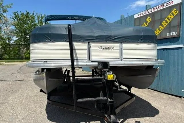 Slide: The Image of 2008 Sun Tracker Party Barge 18 DLX pontoon boat on trailer, covered and parked outdoors. - 22