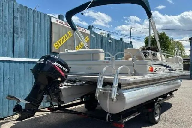 Slide: The Image of 2008 Sun Tracker Party Barge 18 DLX pontoon boat on trailer, with Mercury outboard motor. - 4