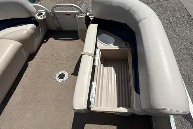 Slide: The Image of 2008 Sun Tracker Party Barge 18 DLX interior with open storage compartment. - 9