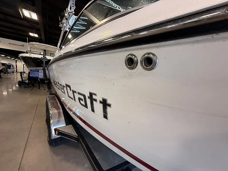 Slide: The Image of 2008 MasterCraft X-15 boat displayed in a showroom. - 2