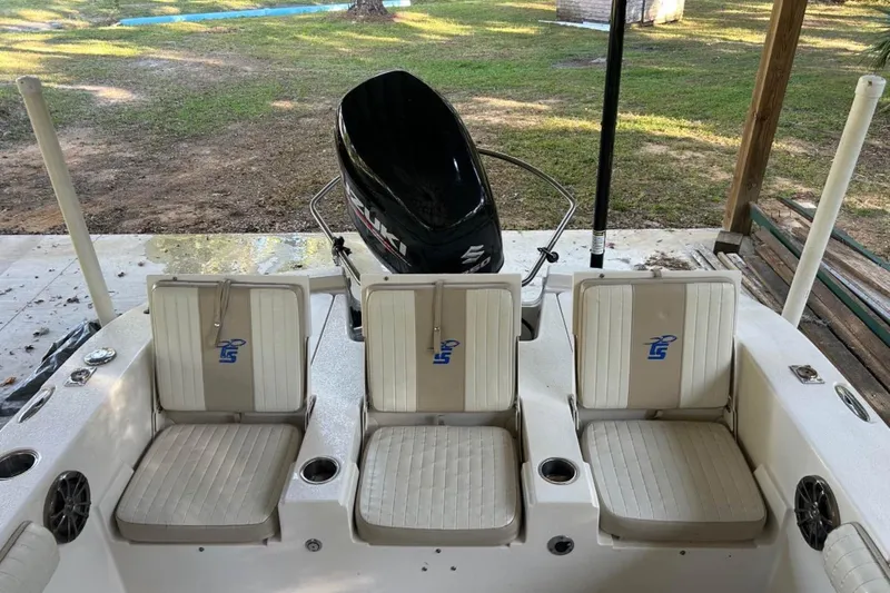 Slide: The Image of 2017 Carolina Skiff 24 Ultra Elite boat interior with seating and motor view. - 6