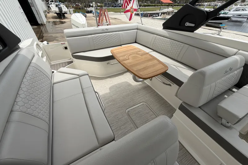 Slide: The Image of Luxurious interior of 2024 Sea Ray SDX 270 Outboard with elegant seating and wooden table. - 12
