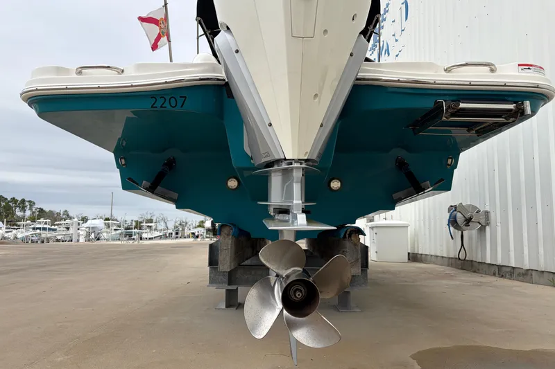 Slide: The Image of 2024 Sea Ray SDX 270 Outboard boat, rear view with propeller, docked outdoors. - 13