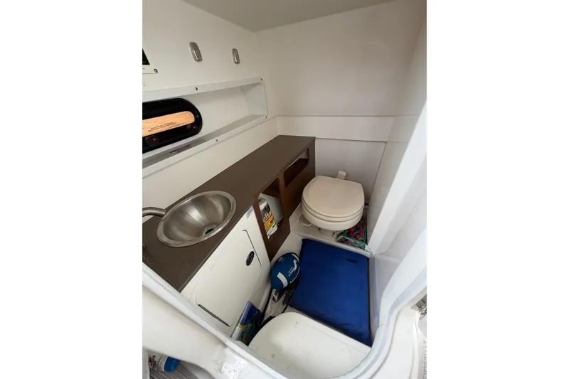 Slide: The Image of 2024 Sea Ray SDX 270 Outboard interior with sink and toilet. - 14