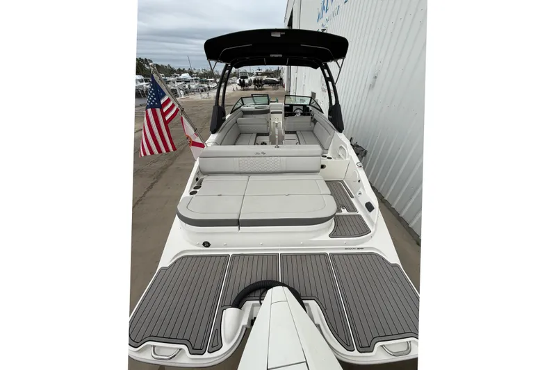 Slide: The Image of 2024 Sea Ray SDX 270 Outboard boat with spacious seating and American flag displayed. - 5