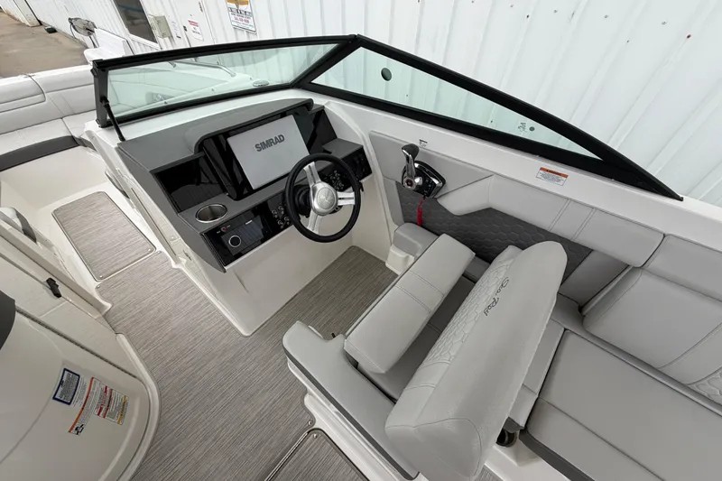 Slide: The Image of 2024 Sea Ray SDX 270 Outboard helm with Simrad display and comfortable seating. - 7