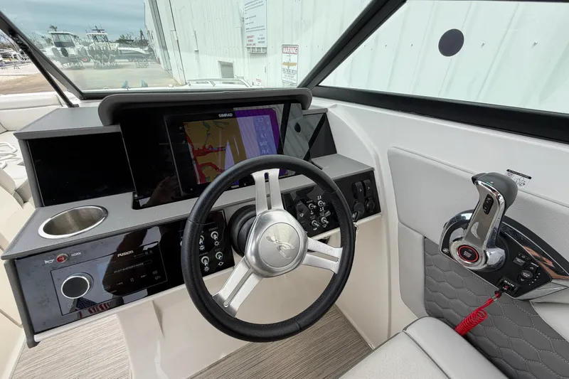 Slide: The Image of 2024 Sea Ray SDX 270 Outboard helm with modern controls and navigation display. - 8