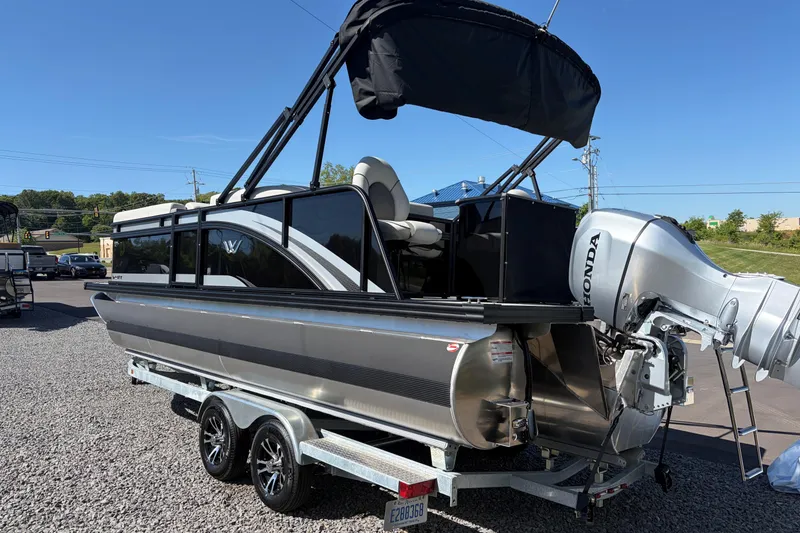 Slide: The Image of 2026 Whisper D21 XRE CRUISE pontoon boat with Honda outboard motor on trailer. - 6