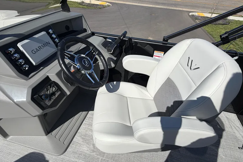 Slide: The Image of Captain's seat and dashboard of 2026 Whisper D21 XRE CRUISE boat with Garmin display. - 7