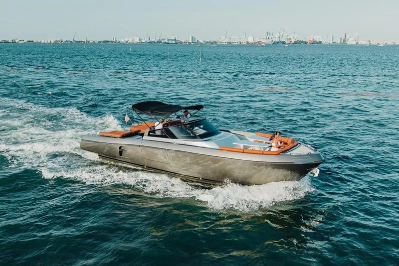 The Image of Luxurious 2015 CNM Continental yacht cruising on open water with city skyline backdrop. - 0
