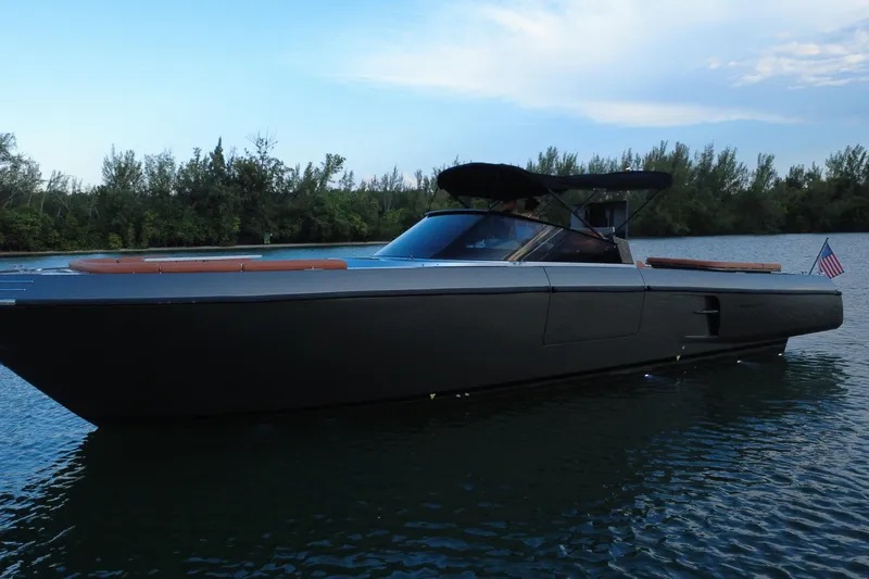 Slide: The Image of Luxurious 2015 CNM Continental yacht on serene water with lush greenery backdrop. - 12