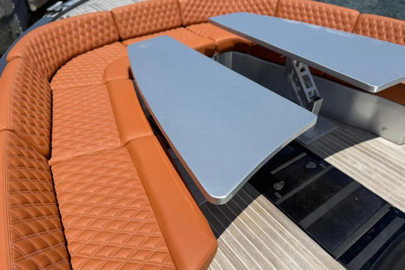 Slide: The Image of Luxurious seating and table on 2015 CNM Continental yacht, featuring quilted leather upholstery. - 13