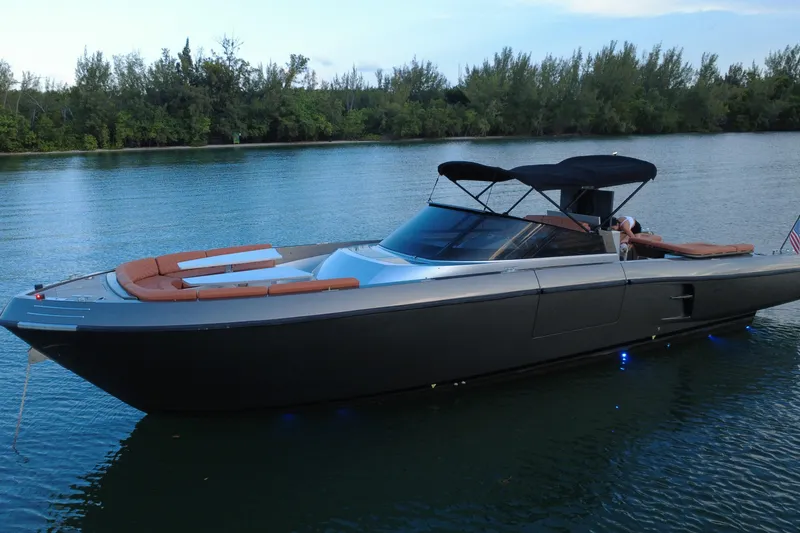 Slide: The Image of Luxurious 2015 CNM Continental yacht on serene water with lush greenery backdrop. - 2