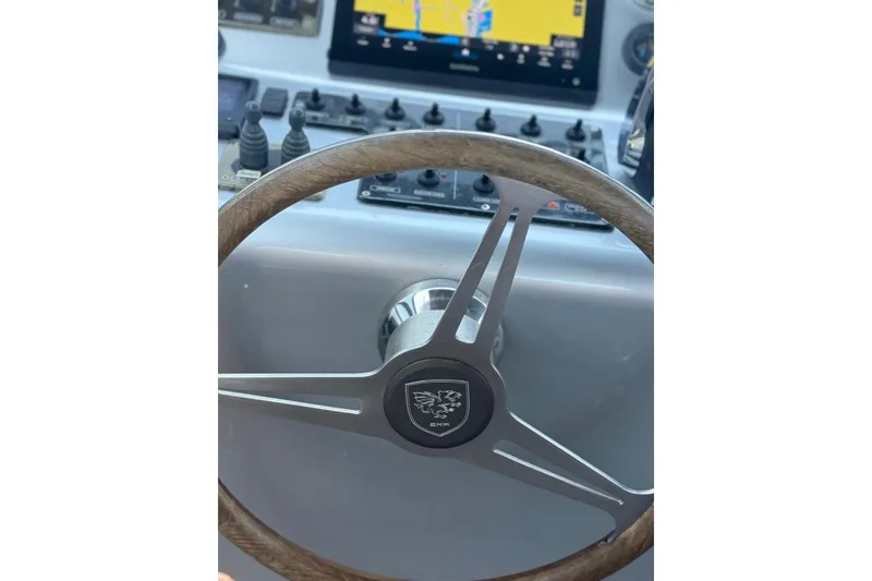 Slide: The Image of Steering wheel of a 2015 CNM Continental yacht with navigation controls. - 22