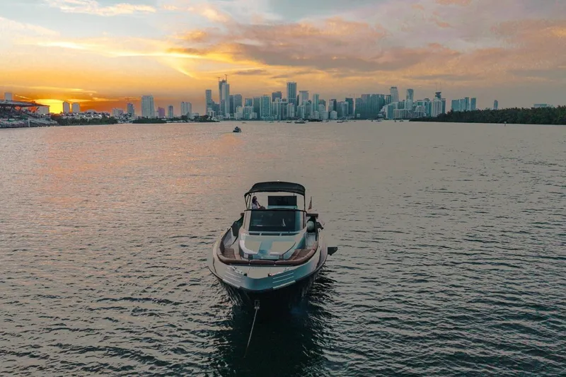 Slide: The Image of Luxury CNM Continental yacht on water with city skyline at sunset, 2015 model. - 24