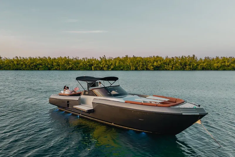Slide: The Image of Luxurious 2015 CNM Continental yacht anchored on serene water with lush greenery backdrop. - 27