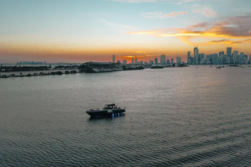 Slide: The Image of A CNM Continental yacht on calm waters at sunset, city skyline in background, 2015 model. - 32
