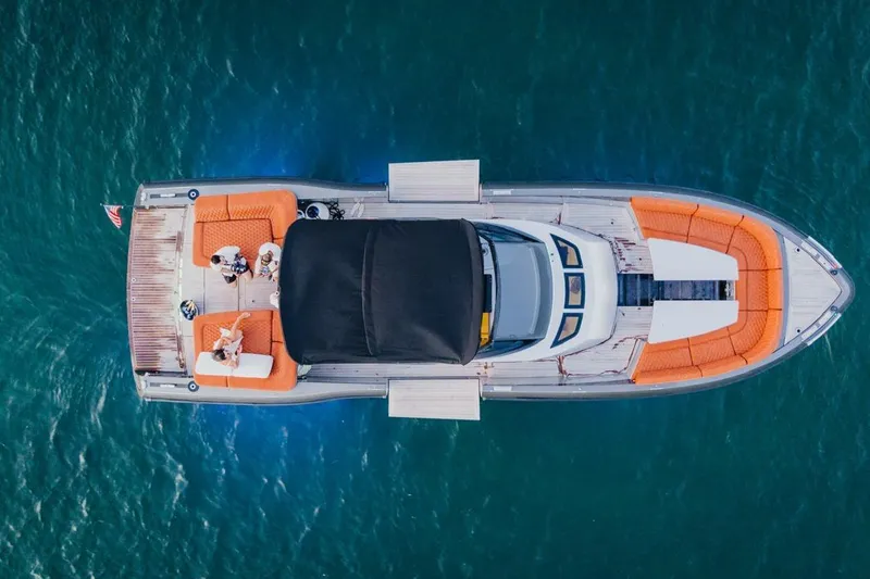 Slide: The Image of Aerial view of 2015 CNM Continental yacht with orange seating on blue water. - 33