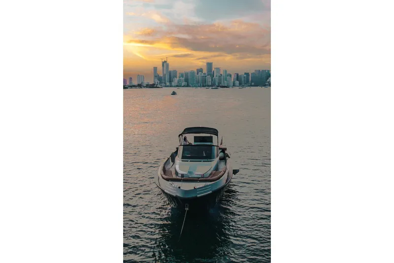 Slide: The Image of Luxury CNM Continental yacht on water with city skyline at sunset, 2015 model. - 36