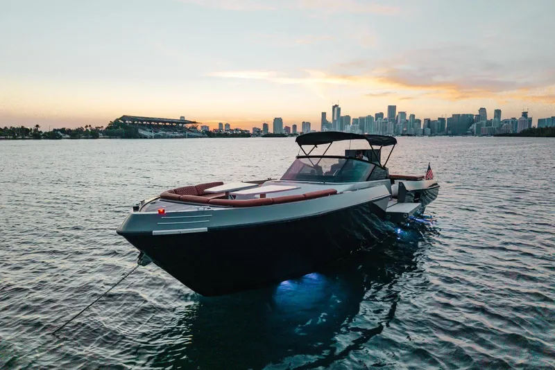 Slide: The Image of Luxurious 2015 CNM Continental yacht at sunset with city skyline backdrop. - 39
