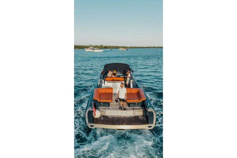 Slide: The Image of Luxury CNM Continental yacht cruising on open water, 2015 model, with passengers enjoying the ride. - 40