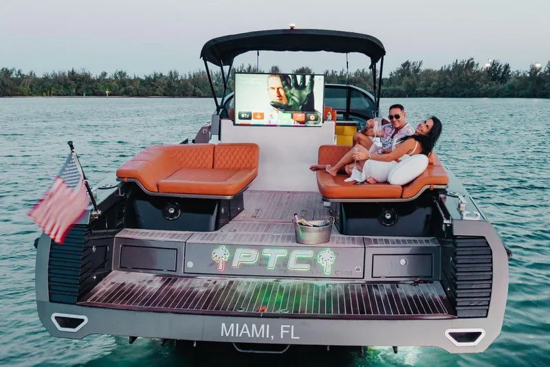 Slide: The Image of Luxury CNM Continental yacht in Miami with lounging couple, 2015 model. - 44