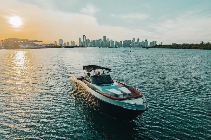 Slide: The Image of Luxury CNM Continental boat cruising near city skyline at sunset, 2015 model. - 45