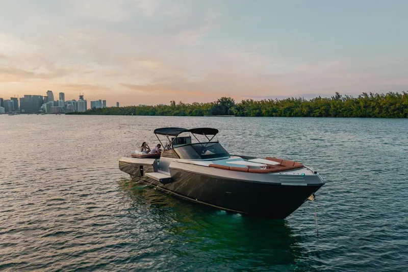 Slide: The Image of Luxury CNM Continental yacht on serene water with city skyline at sunset, 2015 model. - 46