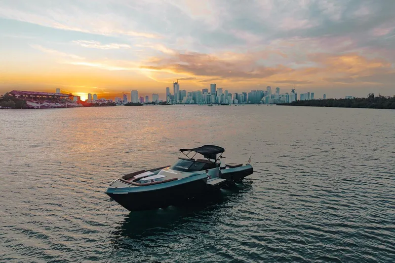 Slide: The Image of Luxury CNM Continental yacht on water at sunset with city skyline. - 50